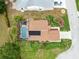 Aerial view of a single Gathering home featuring a private screened-in pool and well-manicured lawn at 25409 Waterbrook Ct, Leesburg, FL 34748