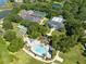 A high angle shows the clubhouse, pool, tennis and shuffleboard courts of this beautiful community at 25409 Waterbrook Ct, Leesburg, FL 34748