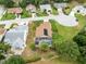 Aerial shot of homes in the neighborhood with lush landscaping and greenery around a house with a pool at 25409 Waterbrook Ct, Leesburg, FL 34748