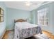 Bright bedroom featuring a cozy bed, a ceiling fan, and natural light from the large window at 25409 Waterbrook Ct, Leesburg, FL 34748