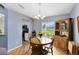 Bright dining area featuring wood floors, a chandelier, and a built-in hutch at 25409 Waterbrook Ct, Leesburg, FL 34748