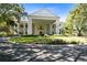 A grand exterior view showcasing a stately building with large columns and a well-maintained lawn at 25409 Waterbrook Ct, Leesburg, FL 34748