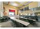 A spacious hall with rows of tables and chairs, a stage, and high ceilings with chandeliers at 25409 Waterbrook Ct, Leesburg, FL 34748