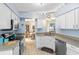 Well-lit kitchen featuring white cabinets, stainless steel appliances, and generous counter space at 25409 Waterbrook Ct, Leesburg, FL 34748