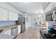 This kitchen boasts stainless steel appliances, white cabinets, and ample counter space at 25409 Waterbrook Ct, Leesburg, FL 34748