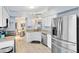 Bright, open kitchen with stainless steel appliances and a view to the dining area at 25409 Waterbrook Ct, Leesburg, FL 34748