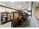 A library with bookshelves filled with books, a cozy reading area, and natural light streaming in at 25409 Waterbrook Ct, Leesburg, FL 34748