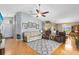 Spacious living room featuring hardwood floors, neutral walls, vaulted ceilings, and plenty of seating perfect for relaxing at 25409 Waterbrook Ct, Leesburg, FL 34748