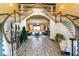 A grand staircase in the lobby featuring curved railings, elegant lighting, and beautiful hardwood flooring at 25409 Waterbrook Ct, Leesburg, FL 34748