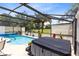 Outdoor spa and pool surrounded by the privacy of a screened-in lanai at 25409 Waterbrook Ct, Leesburg, FL 34748
