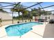 Sparkling in-ground pool and hot tub in a screened lanai, perfect for outdoor enjoyment at 25409 Waterbrook Ct, Leesburg, FL 34748