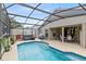 Outdoor swimming pool with lanai, a hot tub, and lounge area, providing a private oasis at 25409 Waterbrook Ct, Leesburg, FL 34748