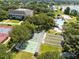 A view of the clubhouse, pool, tennis, and shuffleboard courts within this lovely neighborhood at 25409 Waterbrook Ct, Leesburg, FL 34748