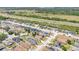 An aerial view of a suburban neighborhood featuring modern homes and well-maintained streets and lawns next to a busy interstate at 2541 Bobby Lee Ln, St Cloud, FL 34772