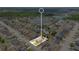 Aerial shot focusing on a highlighted property within a residential area, near a lake and lush greenery, marked with a white outline at 2541 Bobby Lee Ln, St Cloud, FL 34772
