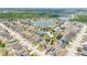 Aerial view of a residential area featuring a scenic lake surrounded by well-maintained homes and green spaces at 2541 Bobby Lee Ln, St Cloud, FL 34772