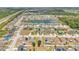 An aerial view showcases a residential neighborhood with a central lake and lush greenery, highlighting the community's appeal at 2541 Bobby Lee Ln, St Cloud, FL 34772