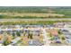 An aerial view of a residential neighborhood near a highway, showcasing the well-maintained lawns and green landscape at 2541 Bobby Lee Ln, St Cloud, FL 34772