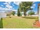 Spacious backyard with lush lawn, mature trees and white perimeter fence at 2541 Bobby Lee Ln, St Cloud, FL 34772