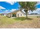 Backyard with a covered patio, white fence and mature landscaping at 2541 Bobby Lee Ln, St Cloud, FL 34772
