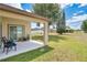 Backyard featuring a covered patio and lush green grass at 2541 Bobby Lee Ln, St Cloud, FL 34772
