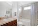 Bright bathroom with a shower-tub combo, and a stylish mirror and vanity at 2541 Bobby Lee Ln, St Cloud, FL 34772