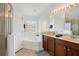 Bright bathroom featuring double vanities, a soaking tub, and a separate glass-enclosed shower at 2541 Bobby Lee Ln, St Cloud, FL 34772