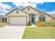 Charming single-story home with a well-manicured lawn, a two-car garage, and inviting curb appeal at 2541 Bobby Lee Ln, St Cloud, FL 34772