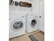 Laundry room featuring white washer and dryer, wire shelving and neutral vinyl flooring at 2541 Bobby Lee Ln, St Cloud, FL 34772