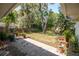 Lush backyard with a stone patio, mature trees, and a fenced-in yard, offering a private outdoor space at 2708 Burton Ln, Orlando, FL 32817