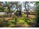 Spacious backyard with mature trees providing shade, enhancing the outdoor living experience at 2708 Burton Ln, Orlando, FL 32817