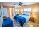 Relaxing bedroom featuring mirrored closet doors, tiled floors, and a comfortable bed with bedside tables and lamps at 2708 Burton Ln, Orlando, FL 32817