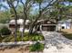 Charming single-story home featuring mature trees, a well-kept lawn, and a convenient two-car garage at 2708 Burton Ln, Orlando, FL 32817