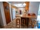 Features a breakfast bar with seating, ample cabinet space, and tile flooring at 2708 Burton Ln, Orlando, FL 32817