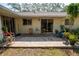 Charming brick patio with outdoor seating, perfect for relaxing or entertaining amidst lush greenery at 2708 Burton Ln, Orlando, FL 32817
