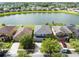 Aerial view of a neighborhood with houses fronting on a lake and lined with trees at 2724 Amanda Kay Way, Kissimmee, FL 34744