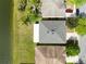 Birds-eye view of a home with an extended patio near the community lake at 2724 Amanda Kay Way, Kissimmee, FL 34744