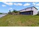 Expansive backyard featuring lush green grass leading to a serene lake at 2724 Amanda Kay Way, Kissimmee, FL 34744