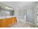 Bathroom featuring a double sink vanity, tiled flooring, separate tub, and glass enclosed shower at 2724 Amanda Kay Way, Kissimmee, FL 34744