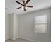 Bright bedroom with tile flooring, neutral walls, ceiling fan, and natural lighting at 2724 Amanda Kay Way, Kissimmee, FL 34744