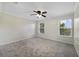 Inviting bedroom featuring a ceiling fan, neutral carpet, and plenty of natural light at 2724 Amanda Kay Way, Kissimmee, FL 34744