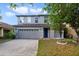 Two-story home featuring a neutral paint scheme, a two car garage, and simple landscaping at 2724 Amanda Kay Way, Kissimmee, FL 34744