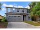 Two-story home featuring a neutral paint scheme, a two car garage, and simple landscaping at 2724 Amanda Kay Way, Kissimmee, FL 34744