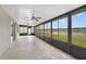 Enclosed lanai overlooking the backyard and lake views through a series of windows at 2724 Amanda Kay Way, Kissimmee, FL 34744