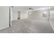 Large carpeted living room with an open layout, abundant natural light, and ceiling fan at 2724 Amanda Kay Way, Kissimmee, FL 34744
