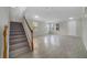 Bright living room featuring neutral paint, tile flooring, a staircase, and natural light at 2724 Amanda Kay Way, Kissimmee, FL 34744