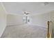 Spacious living room featuring neutral carpet, crown moulding, and bright, natural lighting at 2724 Amanda Kay Way, Kissimmee, FL 34744