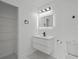 This bathroom has modern lighting, floating vanity, and a built-in linen closet at 274 W 20Th St, Apopka, FL 32703