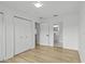This bedroom features light wood floors, a closet for storage, and access to the ensuite bathroom at 274 W 20Th St, Apopka, FL 32703