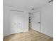 Well-lit bedroom with new flooring, closet and access to the hallway at 274 W 20Th St, Apopka, FL 32703
